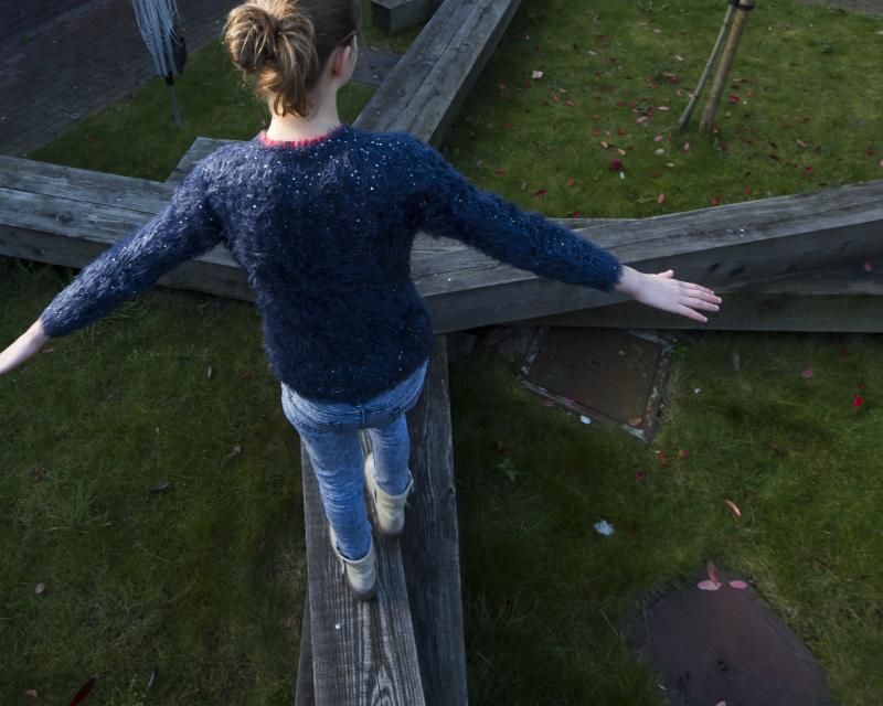 Startpunt jongeren, gesymboliseerd door een jongere die op een kruispunt van balken balanceert en een keuze moet maken